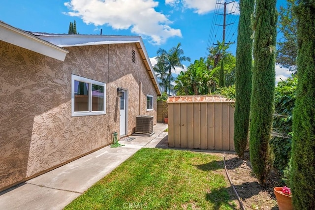 4734 E Tanglewood Ave, Anaheim, CA 92807 - view of grassy yard featuring central AC unit and a patio area