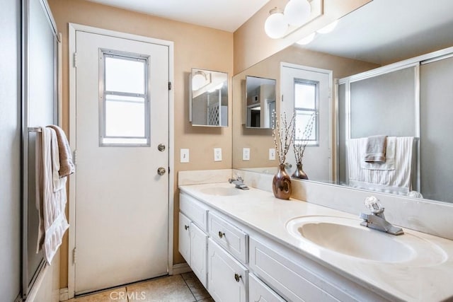 4734 E Tanglewood Ave, Anaheim, CA 92807 - full bath featuring double vanity, tile patterned flooring, and a shower with shower door