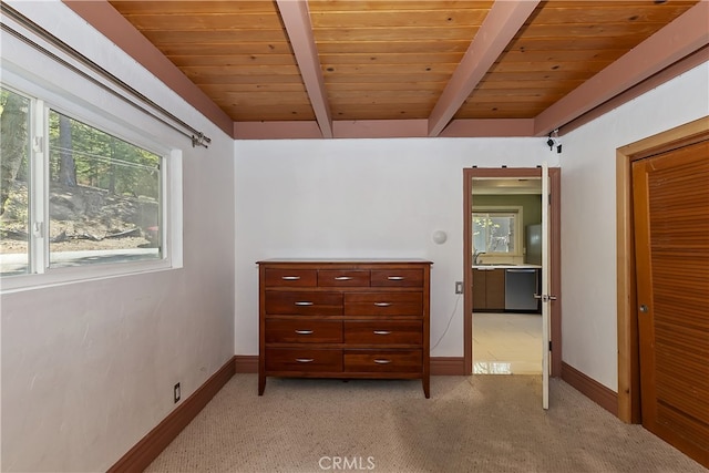 27476 School Rd, Lake Arrowhead, CA 92326 - bedroom featuring wood ceiling with exposed beams, baseboards, light colored carpet, and a sink