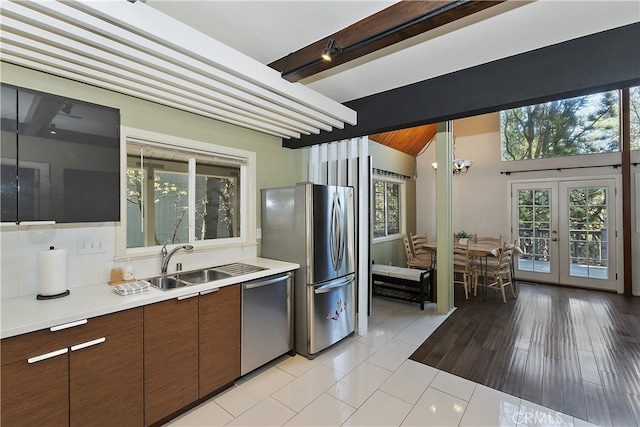 27476 School Rd, Lake Arrowhead, CA 92326 - kitchen featuring appliances with stainless steel finishes, a sink, light countertops, beamed ceiling, and decorative backsplash