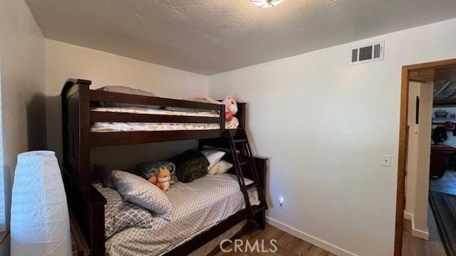 33477 Fern Dr, Green Valley Lake, CA 92341 - bedroom featuring wood finished floors and baseboards
