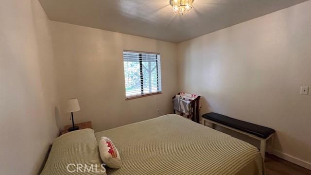 33477 Fern Dr, Green Valley Lake, CA 92341 - bedroom with baseboards and wood finished floors