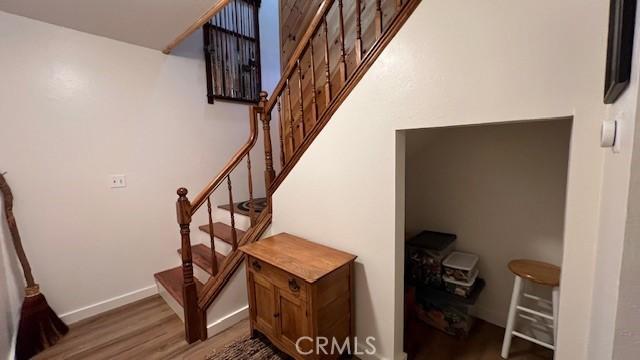 33477 Fern Dr, Green Valley Lake, CA 92341 - staircase featuring wood finished floors and baseboards