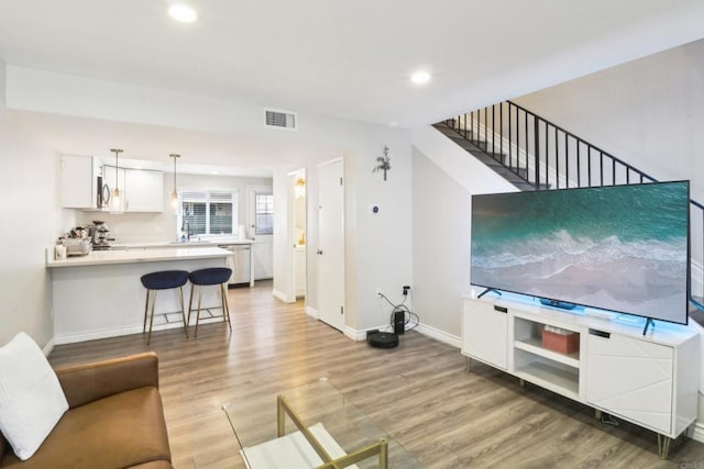 951 Amistad Ct Unit C, El Cajon, CA 92019 - living area with light wood-type flooring, baseboards, recessed lighting, and stairway