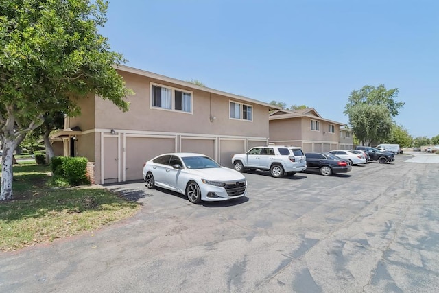951 Amistad Ct Unit C, El Cajon, CA 92019 - view of parking / parking lot featuring a garage