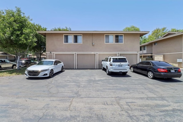 951 Amistad Ct Unit C, El Cajon, CA 92019 - view of front facade with asphalt driveway, stucco siding, and an attached garage