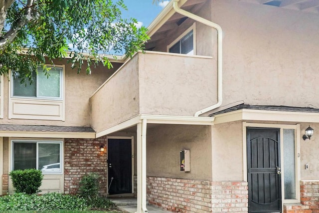 951 Amistad Ct Unit C, El Cajon, CA 92019 - view of exterior entry featuring brick siding and stucco siding