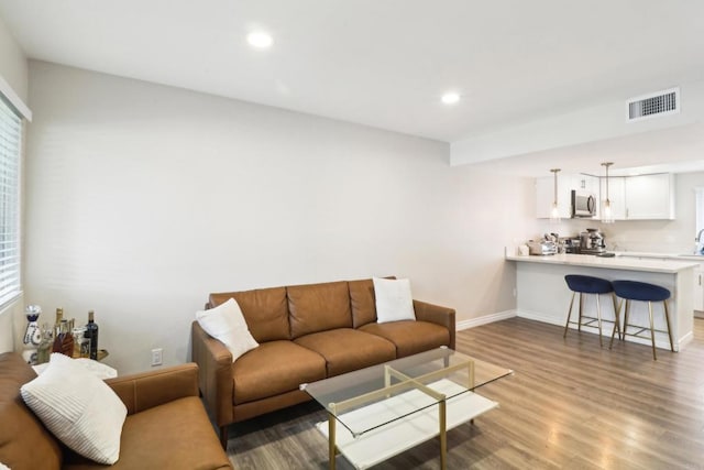 951 Amistad Ct Unit C, El Cajon, CA 92019 - living area with wood finished floors, baseboards, recessed lighting, and plenty of natural light