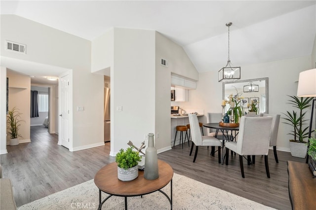 28241 Sorrento Unit 124, Laguna Niguel, CA 92677 - dining space with wood finished floors, baseboards, a chandelier, and high vaulted ceiling