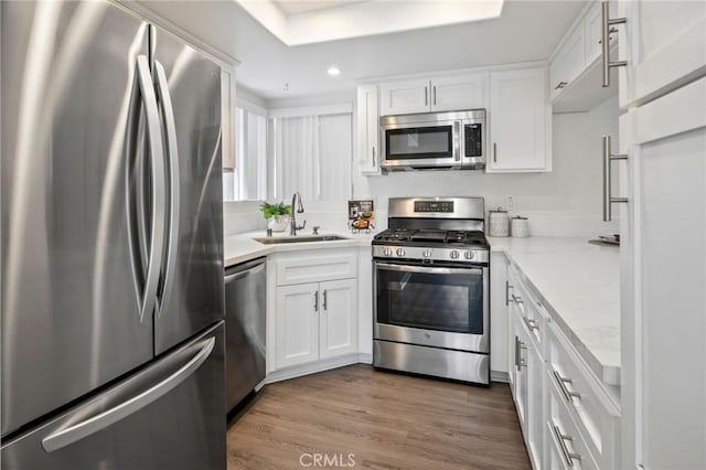 28241 Sorrento Unit 124, Laguna Niguel, CA 92677 - kitchen featuring appliances with stainless steel finishes, a sink, white cabinetry, dark wood finished floors, and recessed lighting