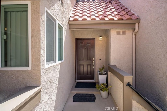 28241 Sorrento Unit 124, Laguna Niguel, CA 92677 - view of exterior entry with stucco siding and a tile roof