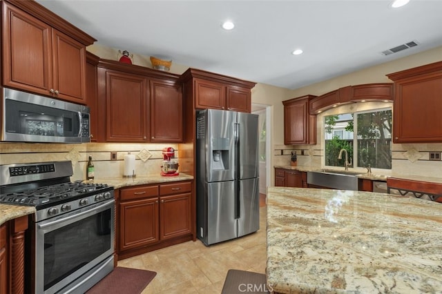 29944 Peach Tree Ct, Murrieta, CA 92563 - kitchen with stainless steel appliances, a sink, recessed lighting, decorative backsplash, and light stone counters