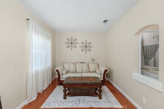 29944 Peach Tree Ct, Murrieta, CA 92563 - living area with wood finished floors, arched walkways, and baseboards