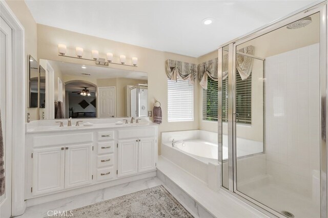 29944 Peach Tree Ct, Murrieta, CA 92563 - bathroom featuring marble look tiles, a garden tub, a stall shower, double vanity, and recessed lighting