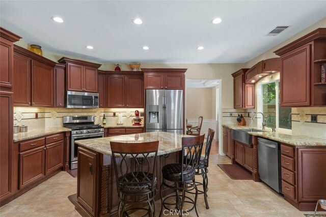 29944 Peach Tree Ct, Murrieta, CA 92563 - kitchen with appliances with stainless steel finishes, a sink, tasteful backsplash, recessed lighting, and a center island