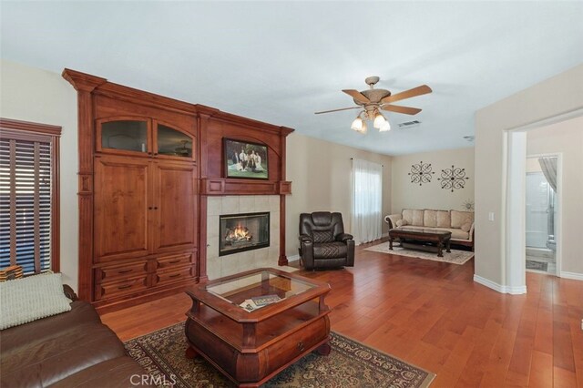 29944 Peach Tree Ct, Murrieta, CA 92563 - living area with a ceiling fan, wood finished floors, a tile fireplace, and baseboards
