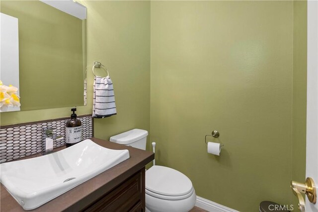 735 Del Valle Dr, Fallbrook, CA 92028 - half bathroom featuring toilet, vanity, and baseboards