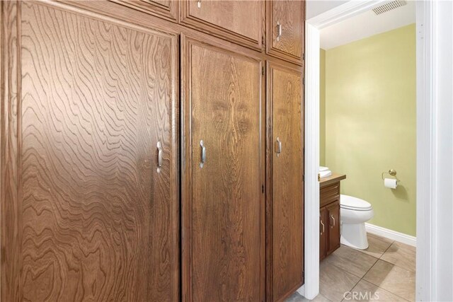 735 Del Valle Dr, Fallbrook, CA 92028 - detailed view of toilet, baseboards, and vanity