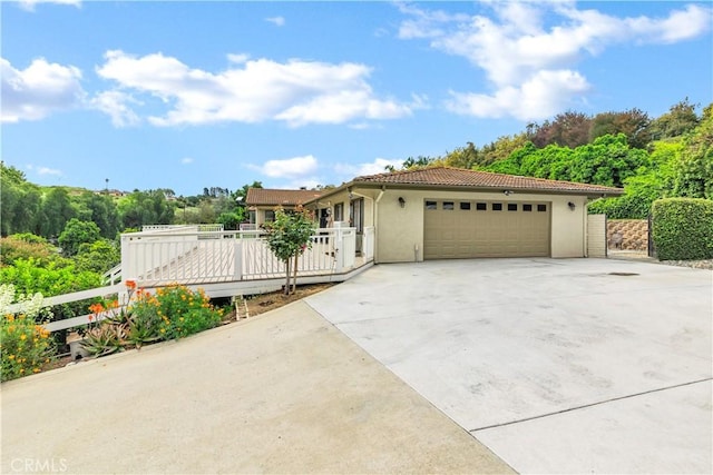 735 Del Valle Dr, Fallbrook, CA 92028 - mediterranean / spanish home featuring a garage, stucco siding, a tile roof, and driveway