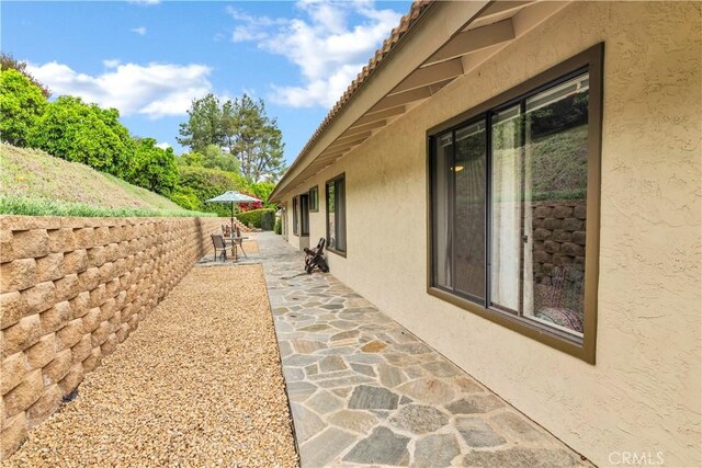 735 Del Valle Dr, Fallbrook, CA 92028 - view of side of property featuring stucco siding and a patio area