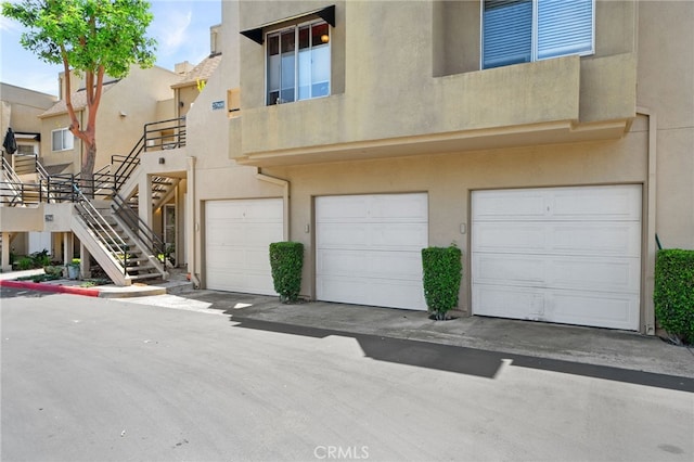 27906 Amber Unit 231, Mission Viejo, CA 92691 - view of property featuring an attached garage and stairs