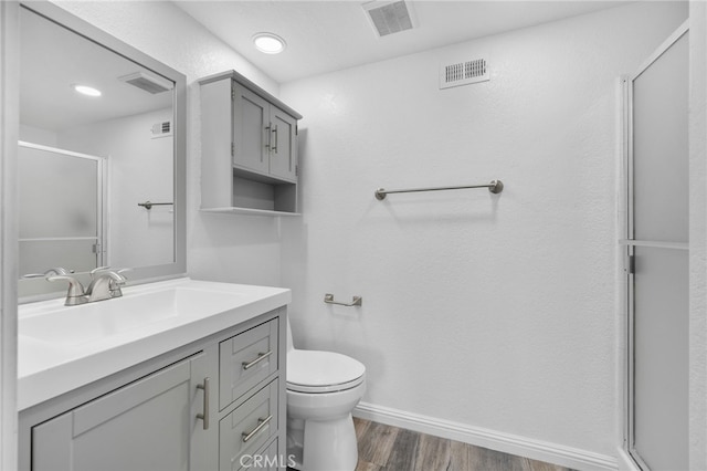 27906 Amber Unit 231, Mission Viejo, CA 92691 - full bathroom with wood finished floors, a stall shower, vanity, toilet, and baseboards