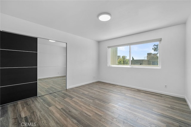 27906 Amber Unit 231, Mission Viejo, CA 92691 - unfurnished bedroom featuring wood finished floors, baseboards, and a closet