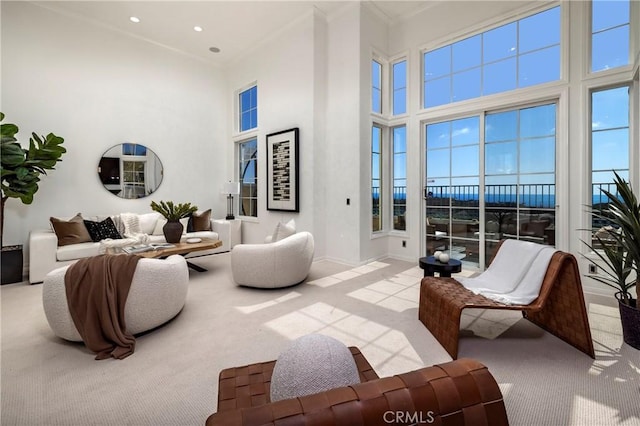 14 Saint Pierre, Newport Coast, CA 92657 - living room with carpet floors, a towering ceiling, ornamental molding, recessed lighting, and baseboards