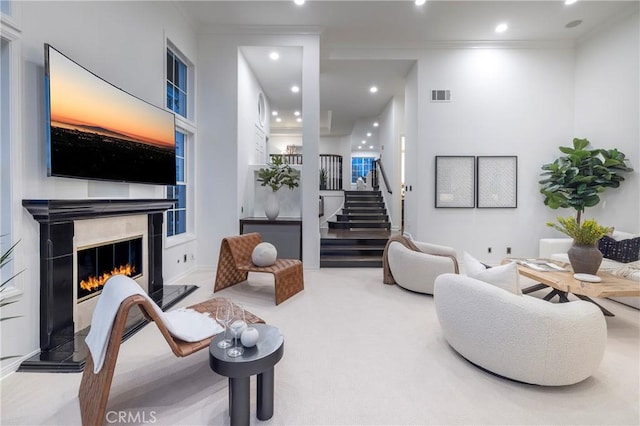 14 Saint Pierre, Newport Coast, CA 92657 - carpeted living area with ornamental molding, stairs, recessed lighting, and a high end fireplace