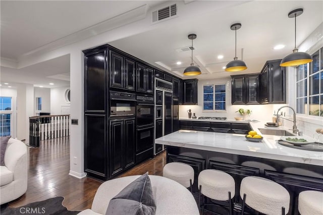 14 Saint Pierre, Newport Coast, CA 92657 - kitchen featuring dark cabinets, a sink, recessed lighting, crown molding, and light stone counters