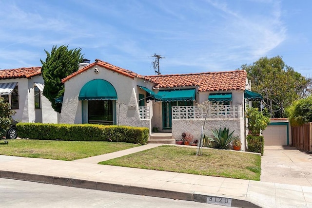 3120 Curtis St, San Diego, CA 92106 - mediterranean / spanish house with a tile roof, a front yard, stucco siding, and concrete driveway