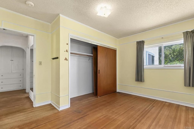 3120 Curtis St, San Diego, CA 92106 - unfurnished bedroom featuring wood finished floors, a textured ceiling, a closet, and ornamental molding