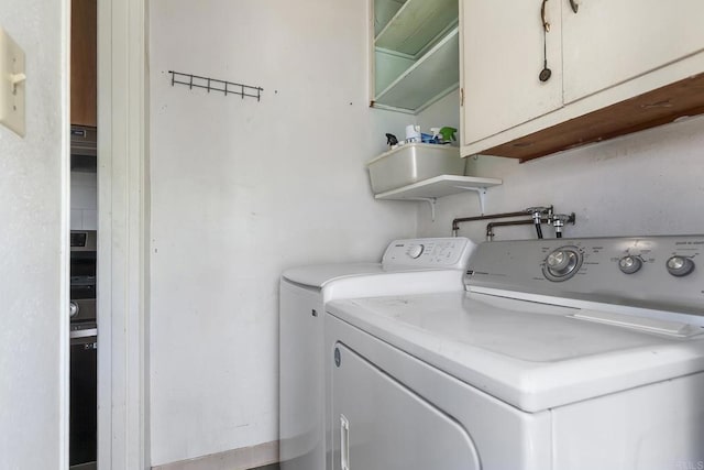 3120 Curtis St, San Diego, CA 92106 - laundry area with washer and clothes dryer and cabinet space
