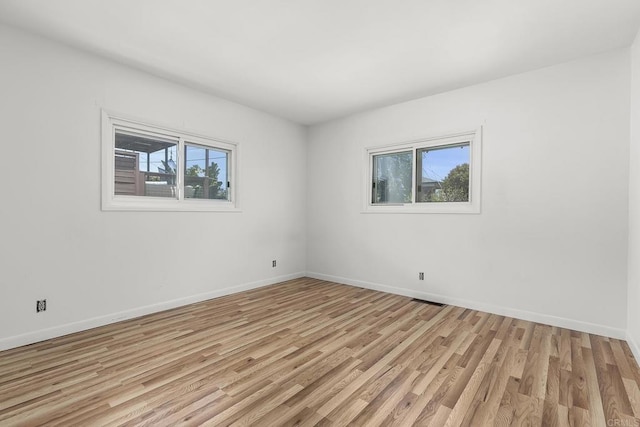 3120 Curtis St, San Diego, CA 92106 - empty room with healthy amount of natural light, light wood-style flooring, and baseboards