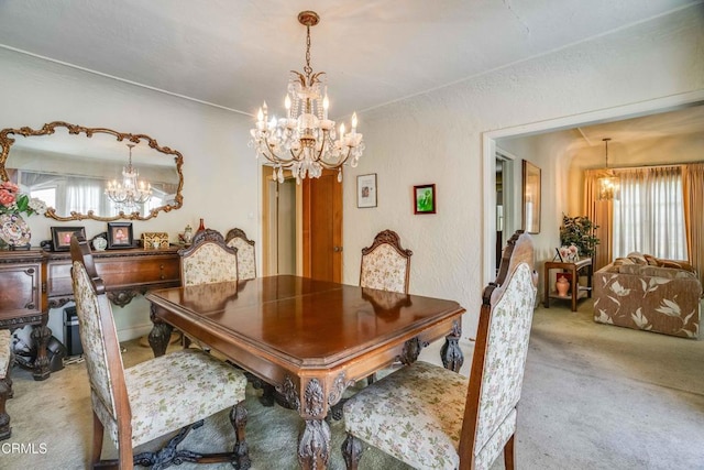 1120 S Burnside Ave, Los Angeles, CA 90019 - dining area featuring a chandelier, plenty of natural light, and carpet floors