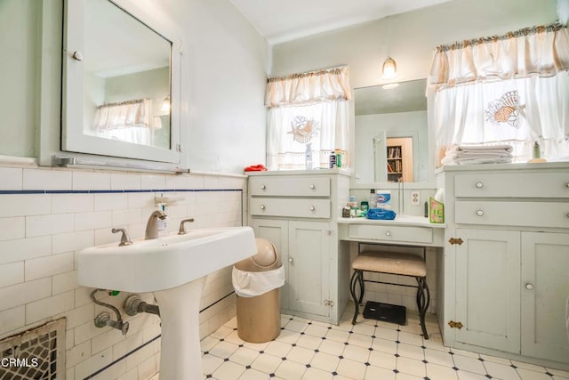 1120 S Burnside Ave, Los Angeles, CA 90019 - bathroom featuring tile patterned floors, tile walls, and a wainscoted wall