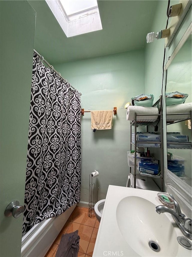 12406 Haley St, Sun Valley, CA 91352 - full bathroom with a skylight, tile patterned flooring, curtained shower, vanity, and toilet