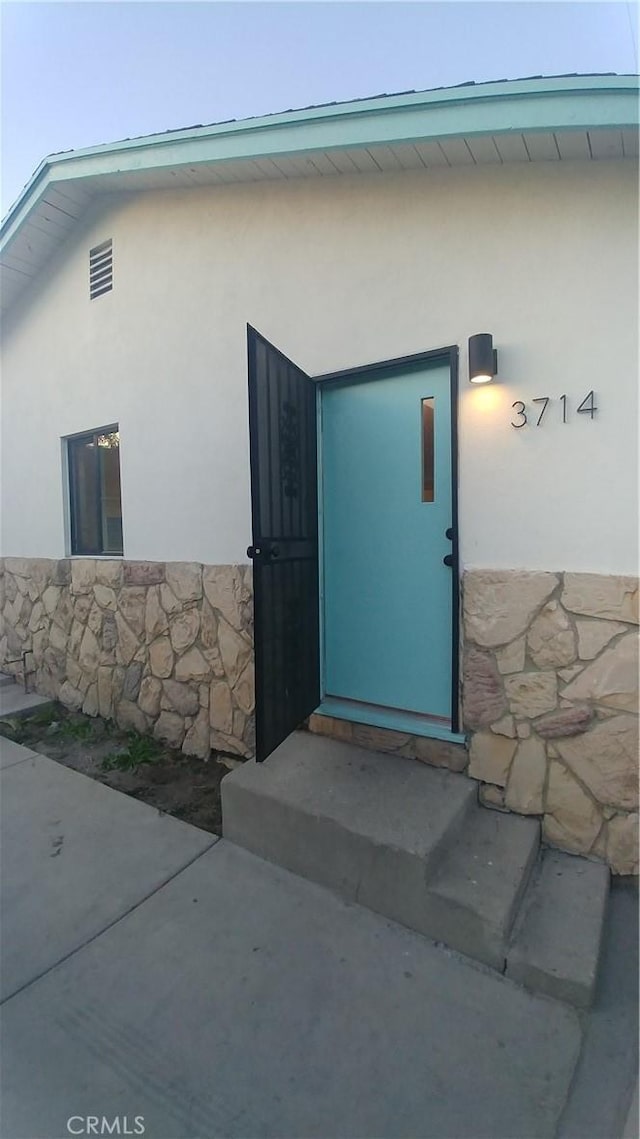 3716 Rosemead Ave, Los Angeles, CA 90032 - view of exterior entry with stucco siding and stone siding