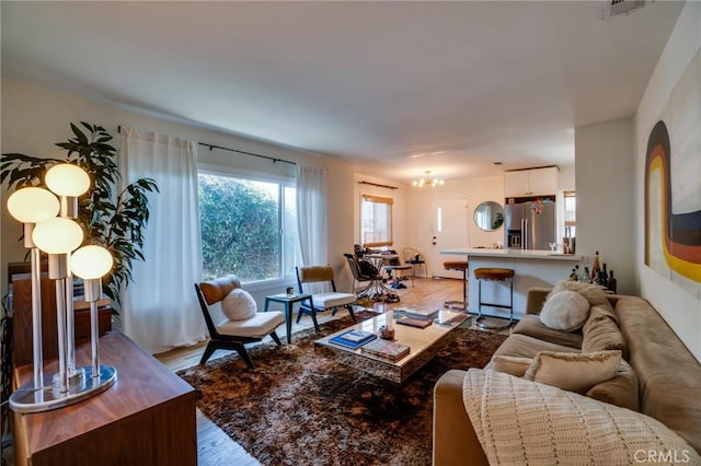3716 Rosemead Ave, Los Angeles, CA 90032 - living area with light wood-style flooring and a chandelier