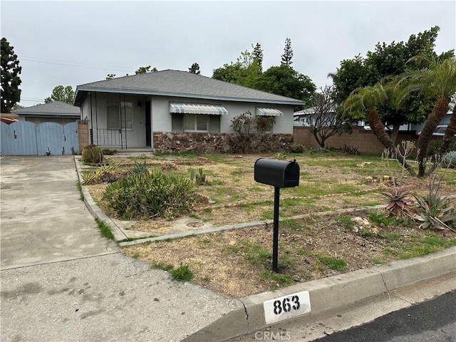 863 S Vanhorn Ave N, West Covina, CA 91790 - view of front of property featuring stucco siding, a gate, driveway, and stone siding