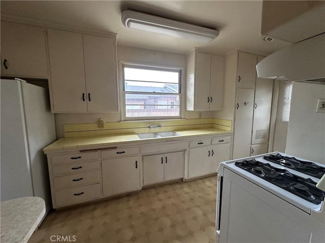 863 S Vanhorn Ave N, West Covina, CA 91790 - kitchen with white appliances, a sink, tile countertops, white cabinetry, and light flooring