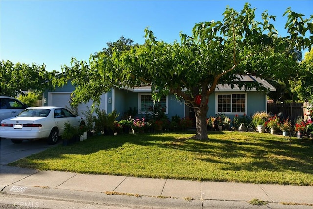 2098 N St, Corning, CA 96021 - view of front facade featuring a garage, a front yard, driveway, and stucco siding
