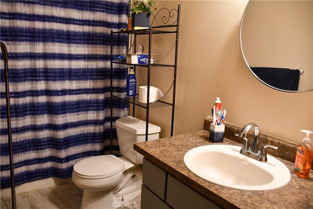 2098 N St, Corning, CA 96021 - bathroom with vanity, toilet, and a textured wall