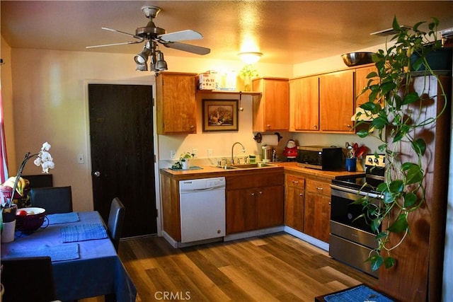 2098 N St, Corning, CA 96021 - kitchen featuring stainless steel appliances, a sink, dark wood-style flooring, a ceiling fan, and brown cabinetry