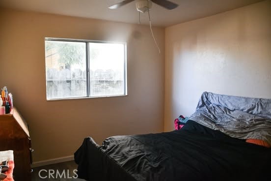 2098 N St, Corning, CA 96021 - bedroom with multiple windows, ceiling fan, and baseboards