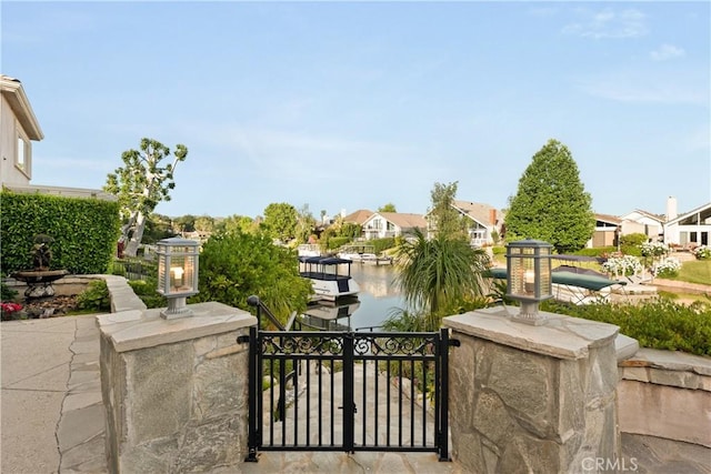 2567 Oakshore, Westlake Village, CA 91361 - view of patio / terrace with a gate, a water view, and a residential view