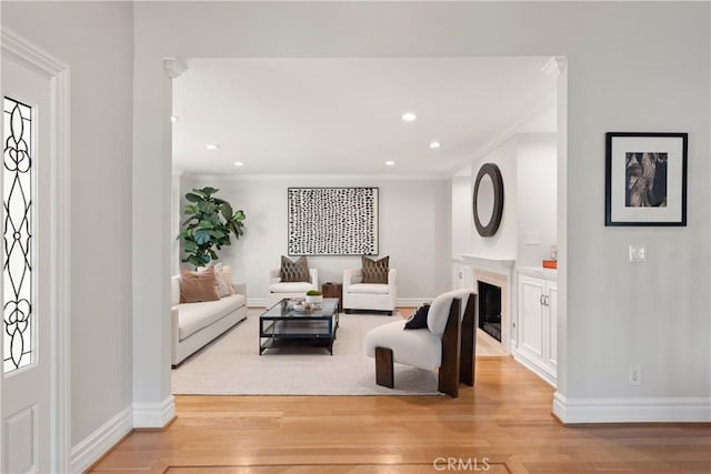 2567 Oakshore, Westlake Village, CA 91361 - living area with ornamental molding, light wood finished floors, recessed lighting, baseboards, and a fireplace