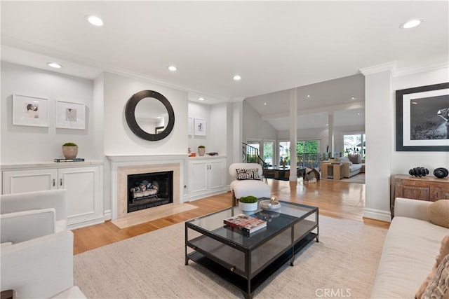 2567 Oakshore, Westlake Village, CA 91361 - living area with light wood-style flooring, recessed lighting, ornamental molding, and a fireplace with flush hearth