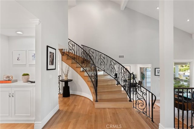 2567 Oakshore, Westlake Village, CA 91361 - staircase featuring high vaulted ceiling, wood finished floors, and baseboards