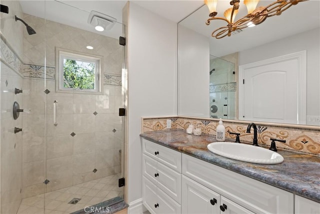 2567 Oakshore, Westlake Village, CA 91361 - full bath with vanity, a shower stall, a chandelier, and backsplash